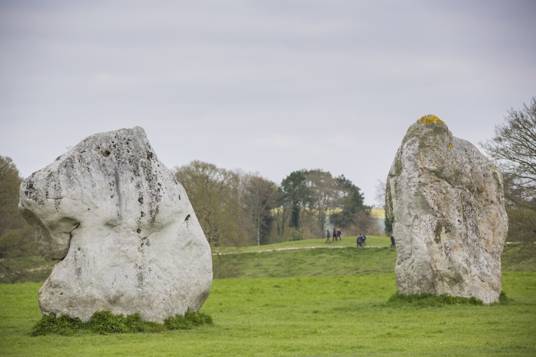 Visitors walking amongst the stones at Avebury, Wiltshire