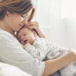 Loving,Mom,Carying,Of,Her,Newborn,Baby,At,Home.,Bright