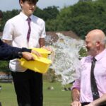 1. Students pour water on Headteacher, Pete Lynch, during Ice Bucket Challenge for Mental Health Awareness Week. copy