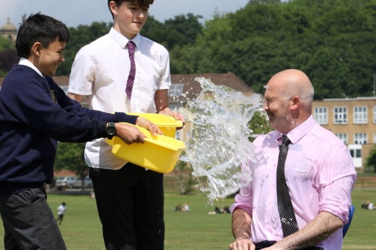 1. Students pour water on Headteacher, Pete Lynch, during Ice Bucket Challenge for Mental Health Awareness Week. copy