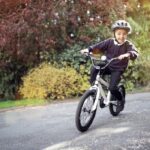Boy,learning,to,ride,his,bike,home,from,school