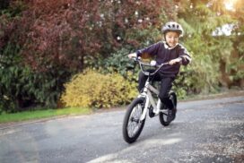 Boy,learning,to,ride,his,bike,home,from,school