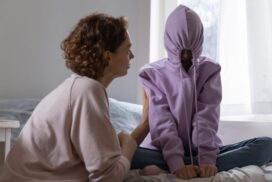 Stubborn,teenage,girl,puts,hood,on,head,avoiding,mom,apology,