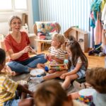 Preschool,teacher,leading,a,fun,interactive,activity,with,children,sitting