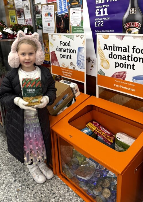A st benedict's pupil makes a donation as one of her acts of kindness