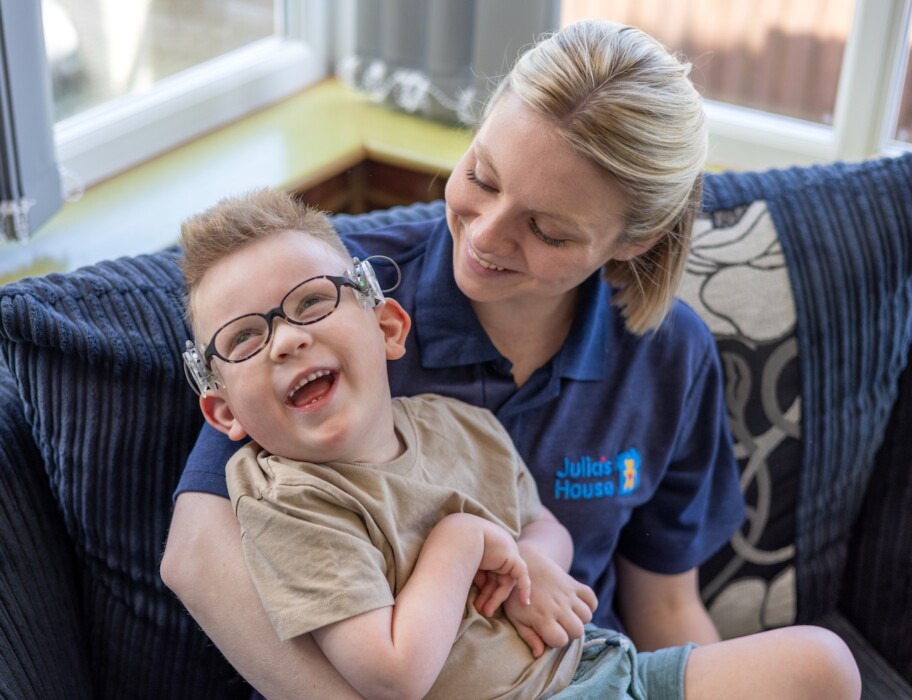 Wilf smiles with Julia's House Nurse Emily (credit Jon Bolton)