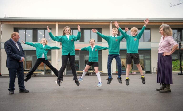 Pupils outside the new energy-efficient classrooms at St Keyna Primary School in Keynsham after the school’s £5.3m expansion