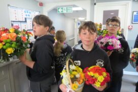 Year 6 pupils from Christ the King Catholic School in Amesbury visited Buckland Court care home, sharing flowers, stories and companionship with residents.