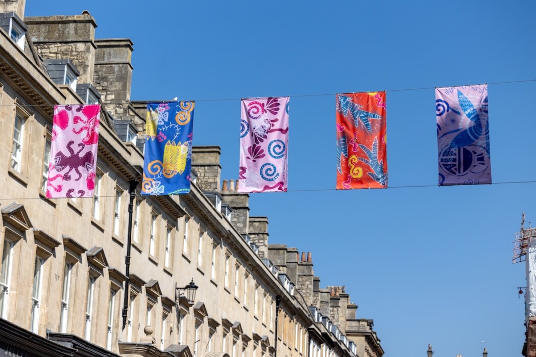 Zandra Rhodes-inspired designs by students from four Bath schools and colleges have been turned into colourful banners and bunting across the Milsom Quarter.